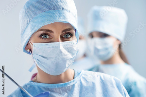 Close-up portrait of young female surgeon doctor