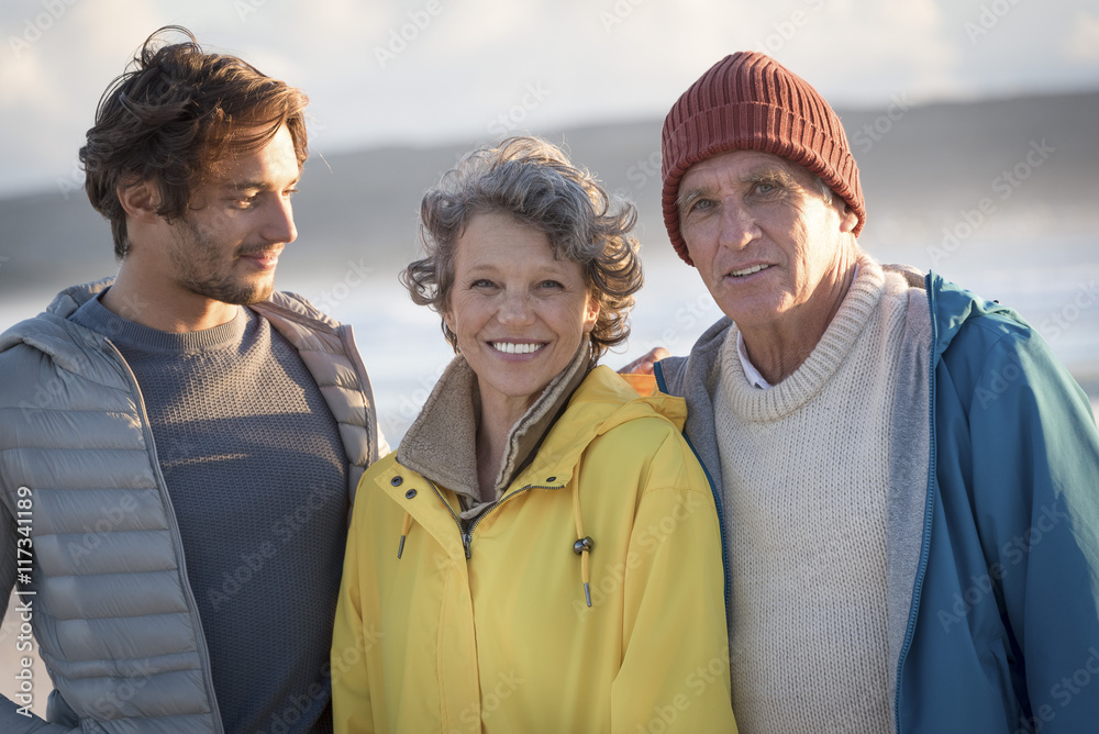 Portrait of happy family standing on the beach Portrait of happy family standing on the beach