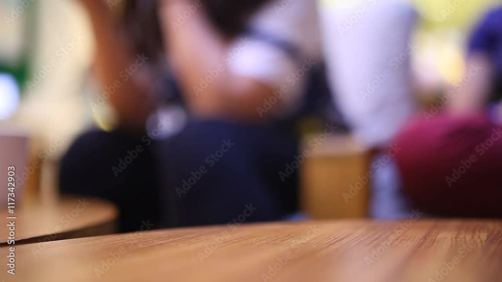 The people play mobile and tablet on the table at cafe blurred background The people play mobile and tablet on the table at cafe blurred background