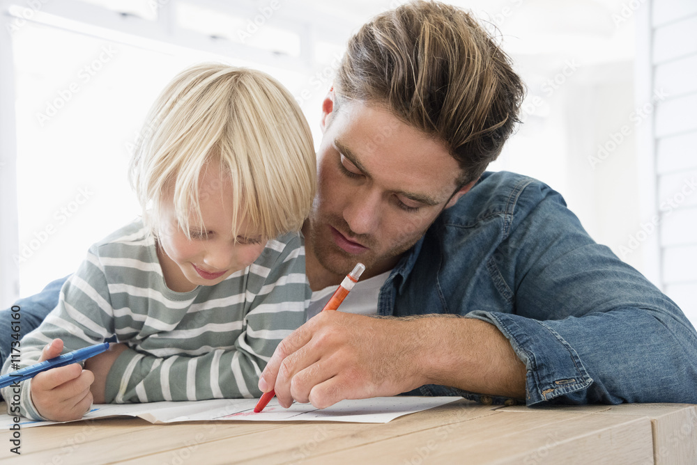 Father helping son with homework Father helping son with homework