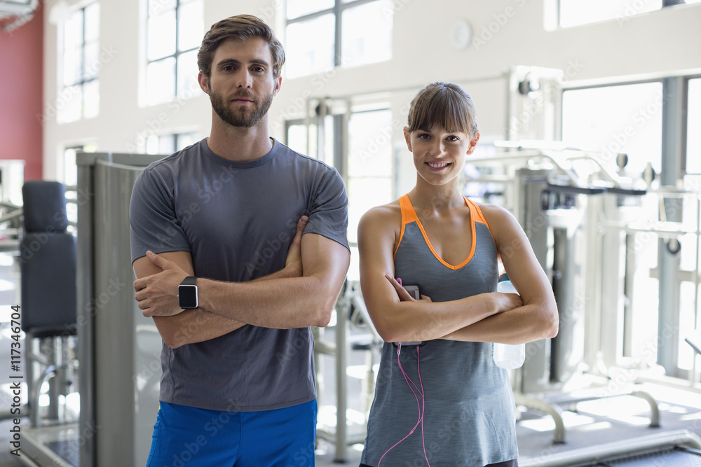 Portrait of a young couple standing in health club Portrait of a young couple standing in health club