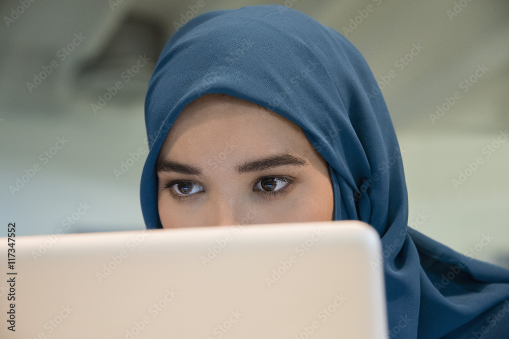 Close-up of an Arab businesswoman using a laptop Close-up of an Arab businesswoman using a laptop