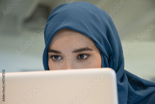 Close-up of an Arab businesswoman using a laptop photo