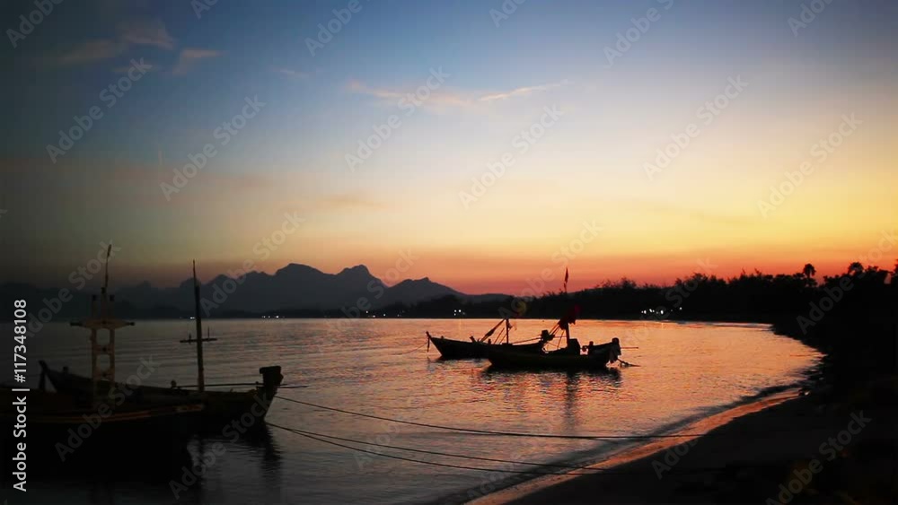 Group of fishing boat anchored at Pranburi beach in Thailand, taken on twilight sunset scene Group of fishing boat anchored at Pranburi beach in Thailand, taken on twilight sunset scene