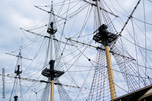 Sailing ship with tall masts against a blue sky