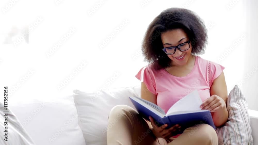 african american young woman reading book at home african american young woman reading book at home