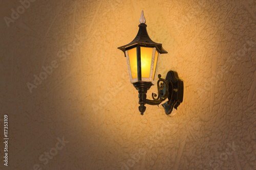 Retro lantern bright on dark wall