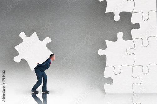 business puzzle concept with businessman and jigsaw