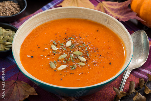 pumpkin soup in a bowl on table