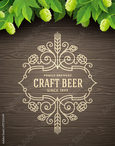 Green hops and flourishes beer emblem on a wooden plank background - vector illustration