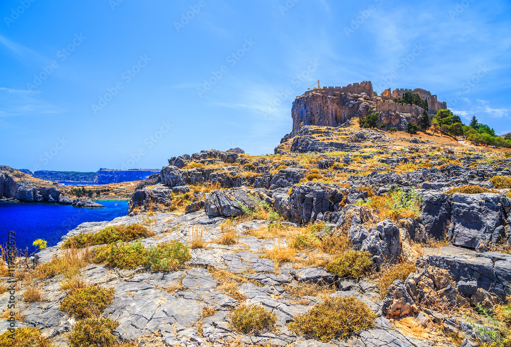 The ancient Acropolis of Lindos and the modern city. Rhodes Island. Greece The ancient Acropolis of Lindos and the modern city. Rhodes Island. Greece