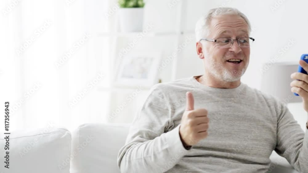 senior man having video call on smartphone at home 94 senior man having video call on smartphone at home 94