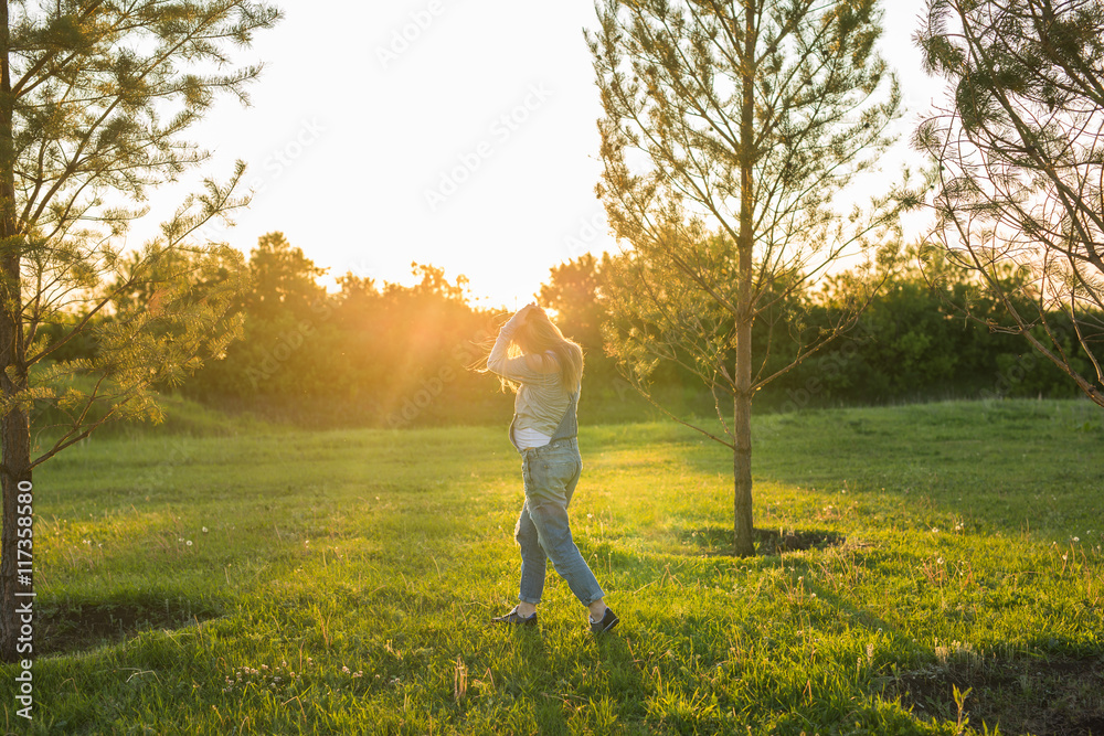young happy pregnant woman relaxing and enjoying life in autumn nature