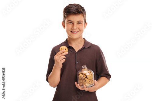 Cuadro en lienzo Child holding a cookie and a jar