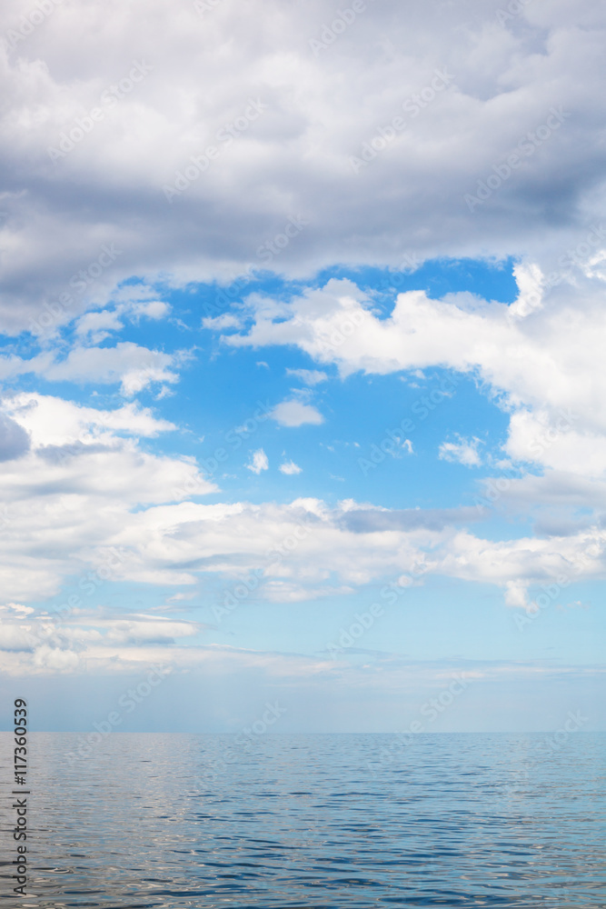 cumulus clouds over calm blue water Sea of Azov