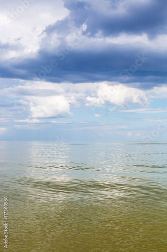 Azov Sea waterscape with green water and blue sky