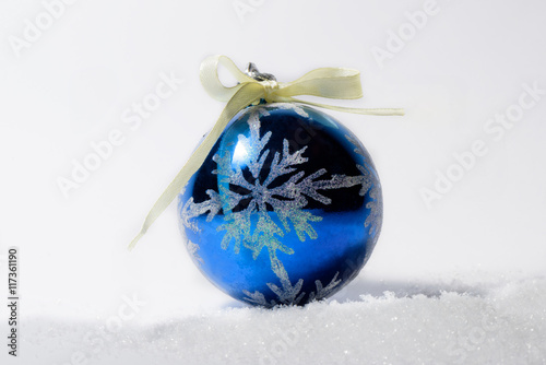 Glass ball Christmas ornament with bow. Christmas decorations in blue color