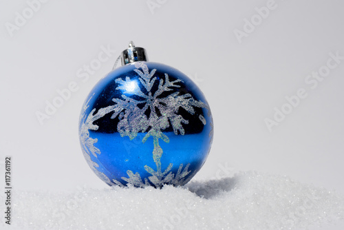 Glass ball Christmas ornament with bow. Christmas decorations in blue color