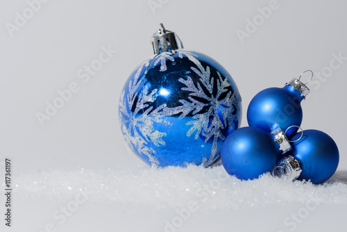 Glass ball Christmas ornament with bow. Christmas decorations in blue color