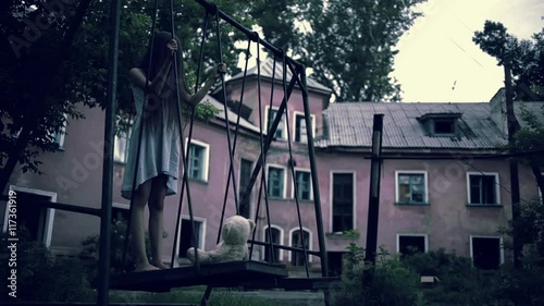 the ghost of a little girl on a swing in the old ruined house. evil spirit