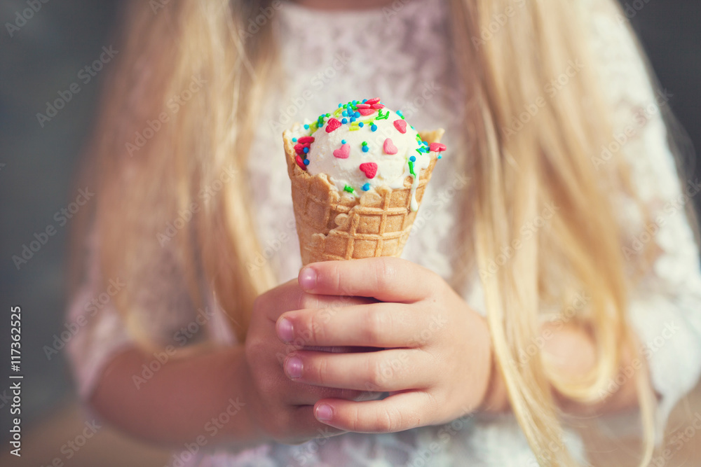 Kid girl eating tasty ice cream