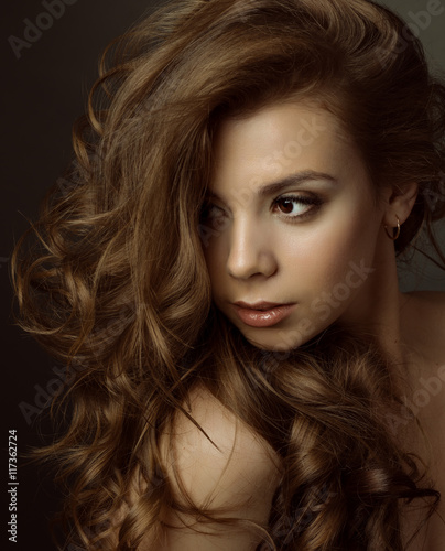 
Portrait of a young beautiful brunette girl with long  hair
