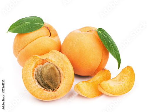 Fresh apricots with green leaves isolated on white