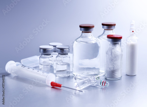 Vials and syringe, studio shot. Medical objects for vaccination. Vaccine drew up into a syringe. 