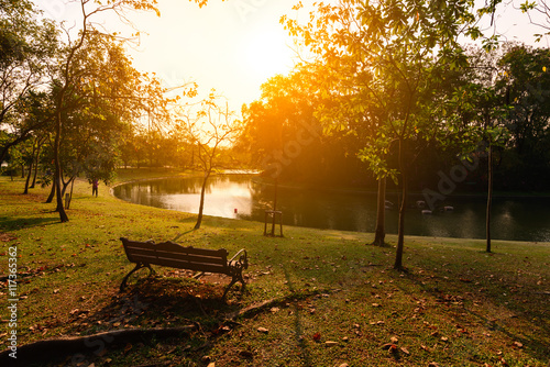 Vintage table with chairs near urban lake in summer.