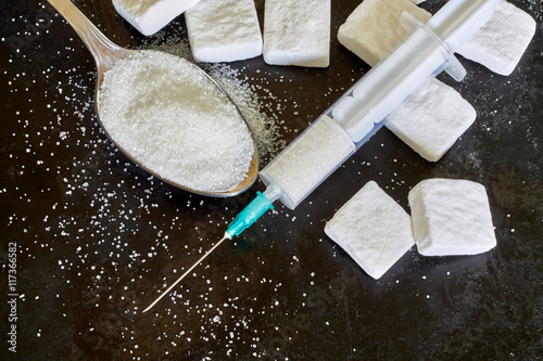 Canvastavla Injection with needle filled with sugar on black rustic background