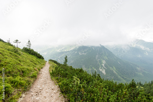 green mountain landscape covered with clouds © Martins Vanags