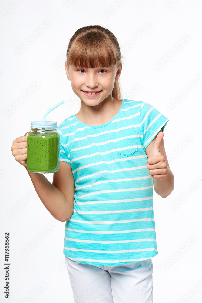 Girl holding jar tumbler mug with green smoothie drink Girl holding jar tumbler mug with green smoothie drink