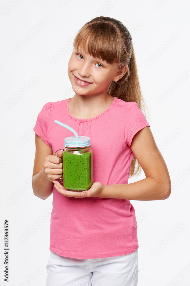 Girl holding jar tumbler mug with green smoothie drink Girl holding jar tumbler mug with green smoothie drink