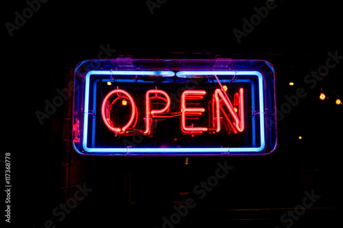 neon OPEN sign welcomes customers photo