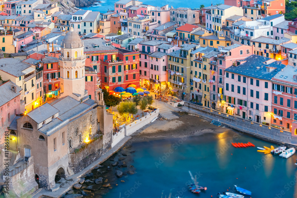 Aerial view of Vernazza fishing village with Santa Margherita di Antiochia Church at sunset, seascape in Five lands, Cinque Terre National Park, Liguria, Italy.