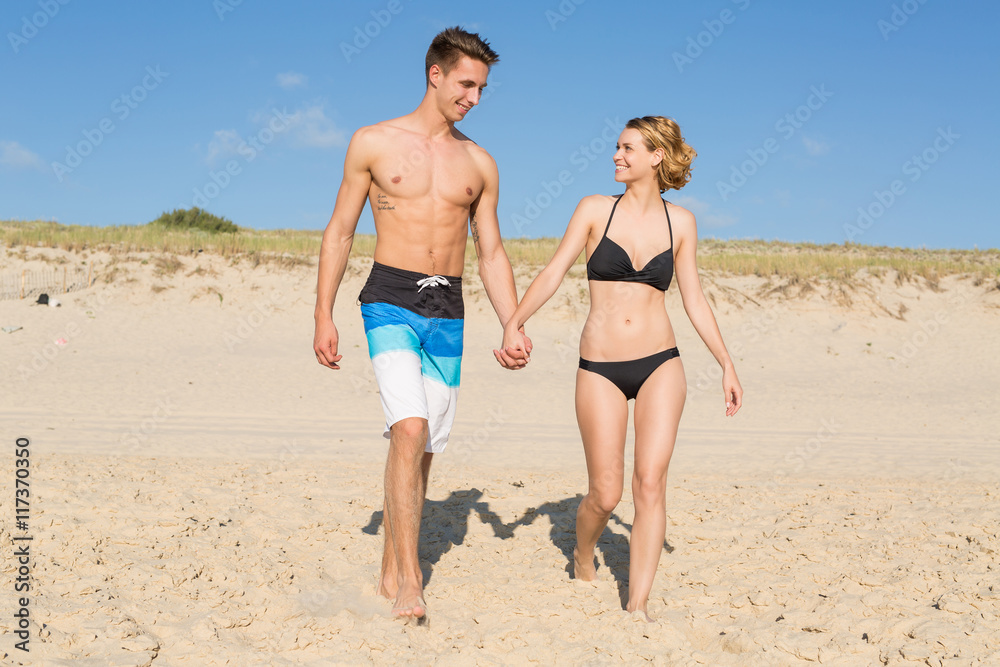 happy couple walking on the beach,Vacation happy couple walking on the beach,Vacation