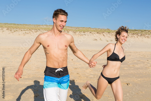 happy couple running on the beach,Vacation