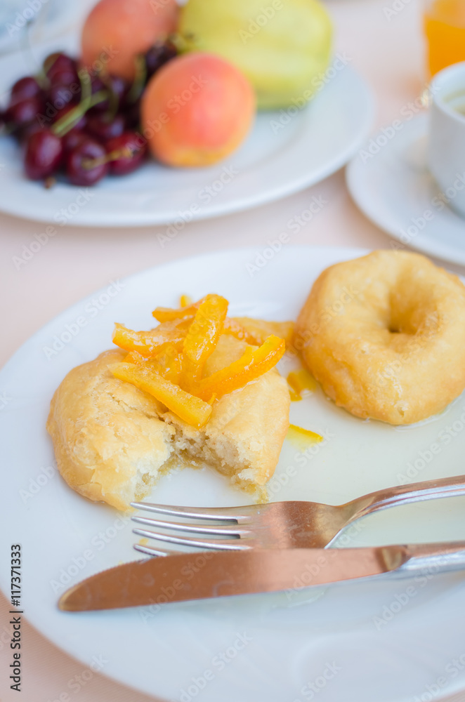 Breakfast including donuts with candied orange jam Breakfast including donuts with candied orange jam