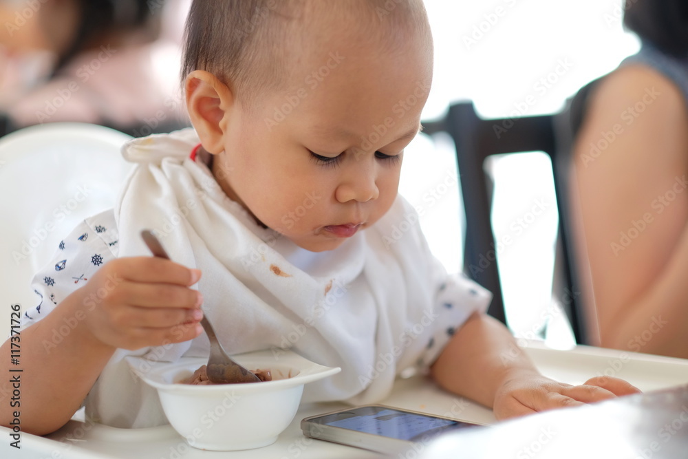 baby boy eating ice cream and Playing smartphone. baby boy eating ice cream and Playing smartphone.