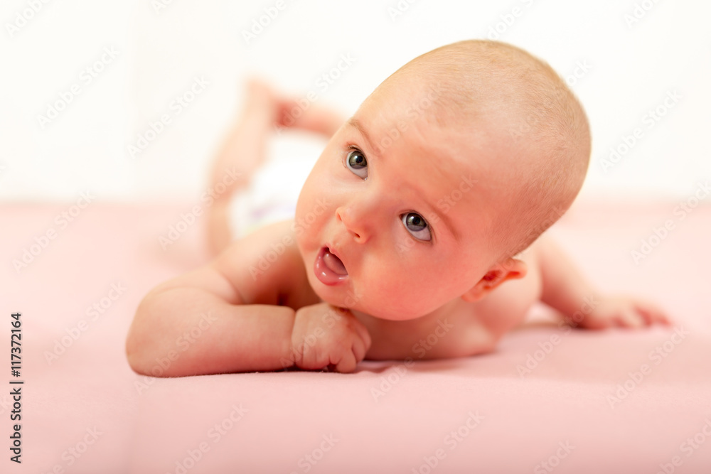 Portrait of adorable baby.Baby lying on his stomach Portrait of adorable baby.Baby lying on his stomach