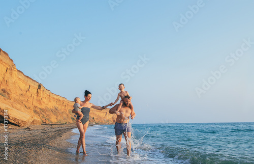 Family with children walking on the sea coast. Family portrait on vacation © Romanova Anna