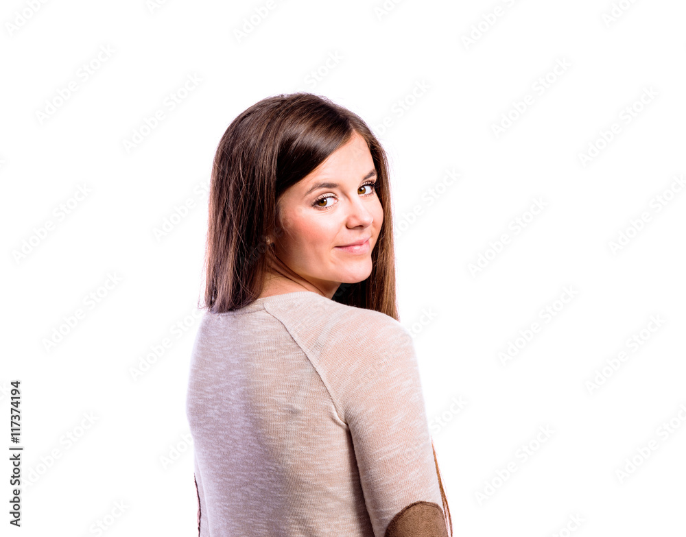 Girl in brown sweater, young woman, studio shot Girl in brown sweater, young woman, studio shot