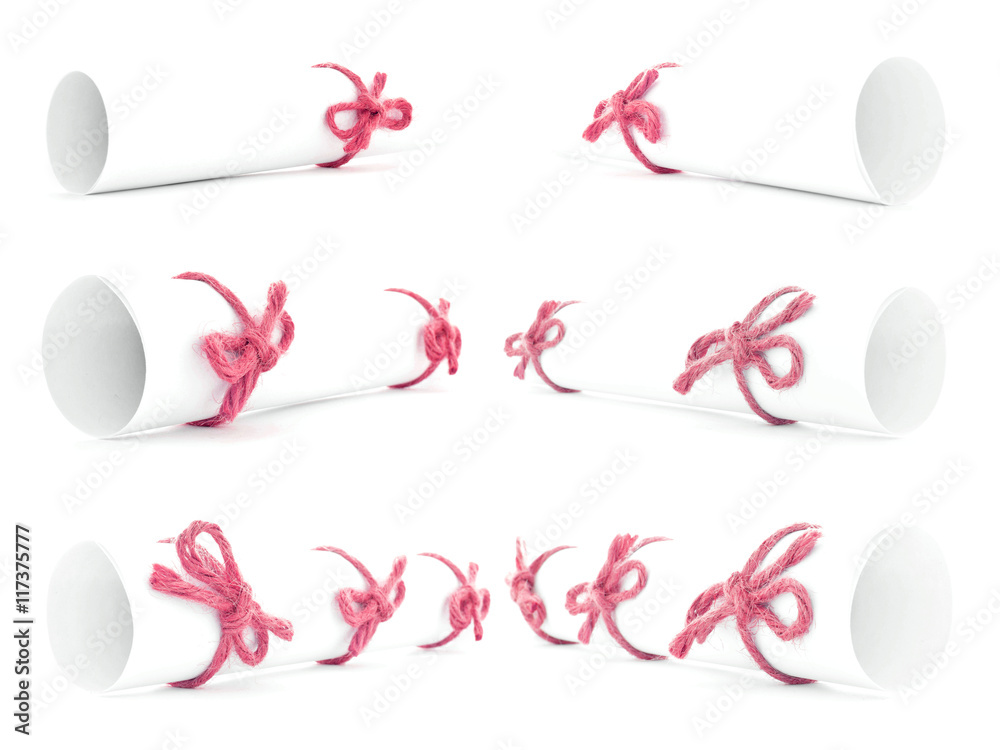 White paper rolls tied with red ropes and nodes isolated White paper rolls tied with red ropes and nodes isolated