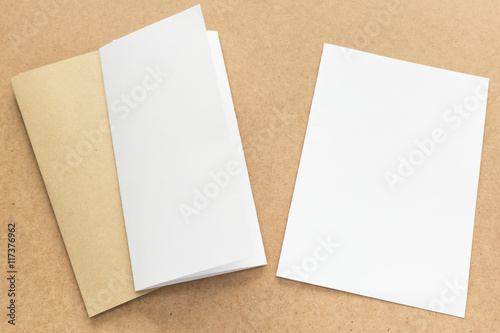 White and brown paper note on business wood desk with copy space
