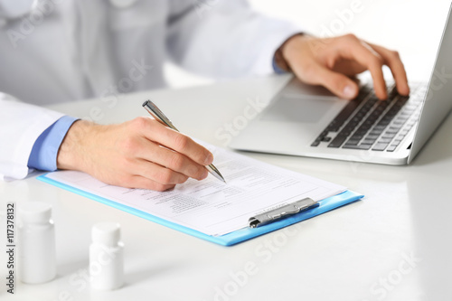 Doctor working at table in ...