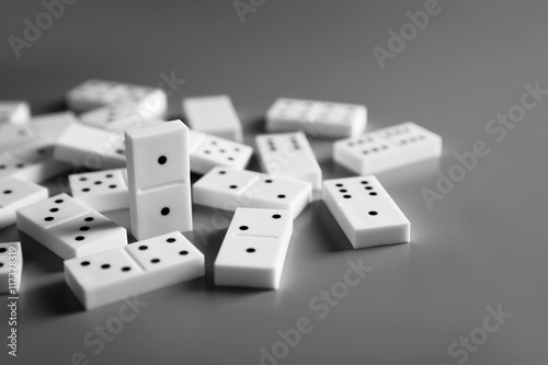 Heap of dominoes on grey background