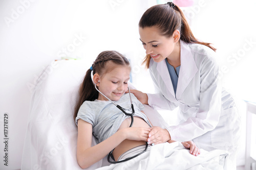 Cute girl visiting doctor