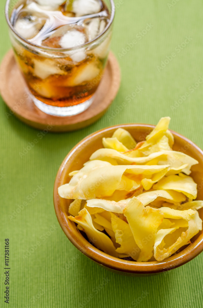 Cola and durian chips fried snack fruit in brown blow on green b