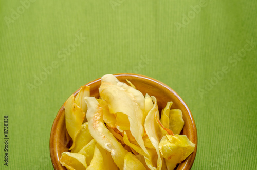 Durian chips fried snack fruit in brown blow on green background