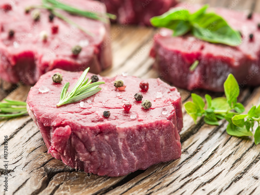 Pieces of beef tenderloin on the wooden cutting board. Pieces of beef tenderloin on the wooden cutting board.